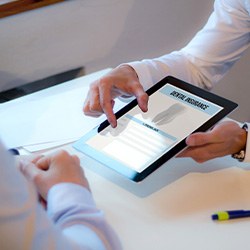 Patient reviewing dental insurance form on tablet