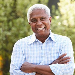 Man smiling while enjoying the outdoors