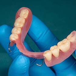 Dentist holding dentures