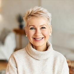 a woman smiling with dental implants in Newburyport