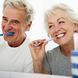 a mature couple brushing their dental implants in Newburyport