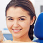 woman sitting in exam chair smiling