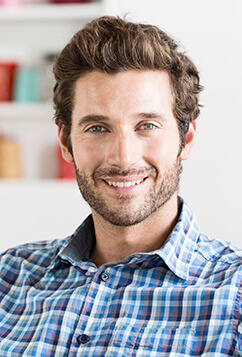 man with beard smiling at camera