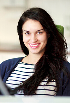 woman wearing white shirt smiling at camera