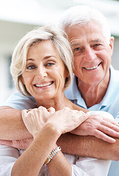 husband hugging wife and smiling