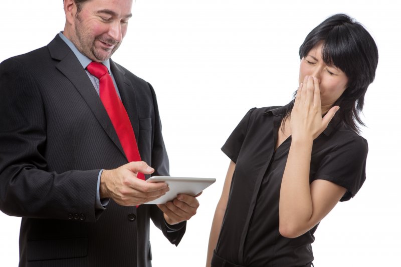 a woman holding her nose next to a man with bad breath