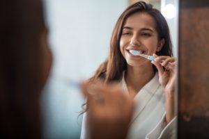 person brushing their teeth 