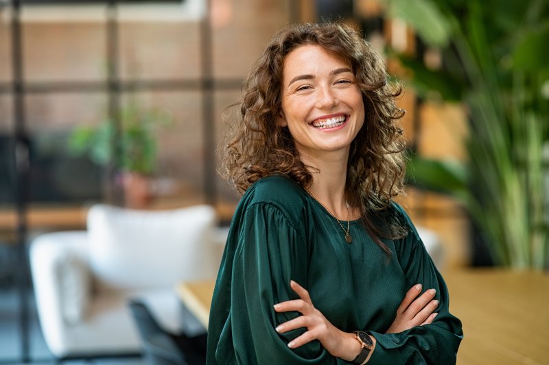 Woman smiles indoors