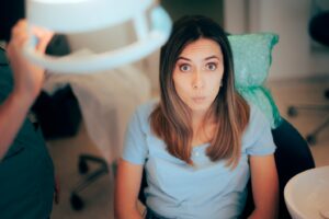 Worried-looking patient sitting in dentist’s chair.