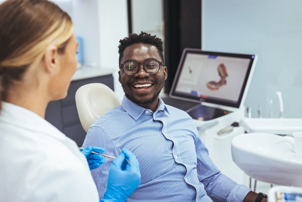 A man smiling at a dental appointment